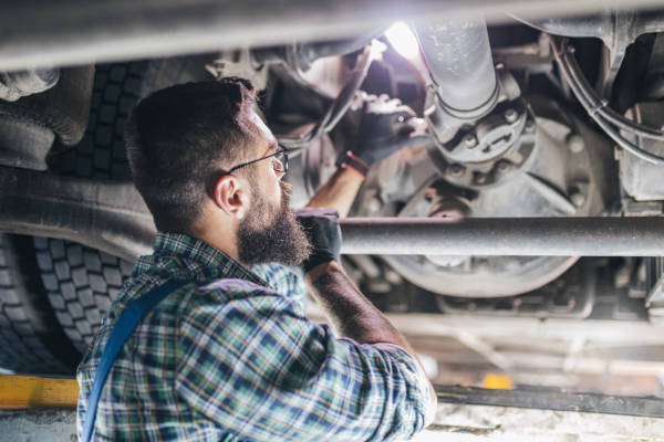 Professional car mechanic working in vehicle repair service.